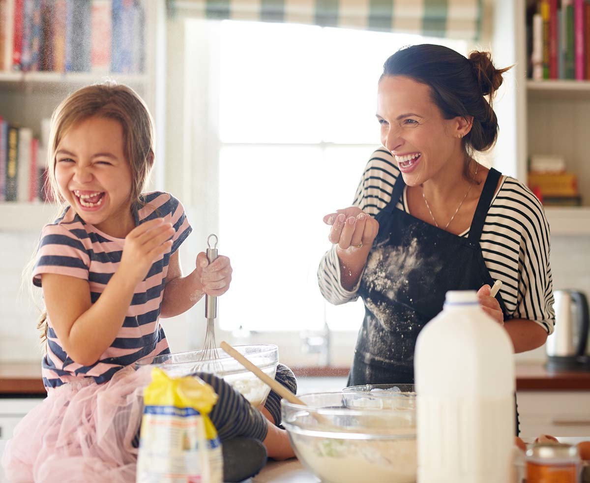Woman and her kid baking food.